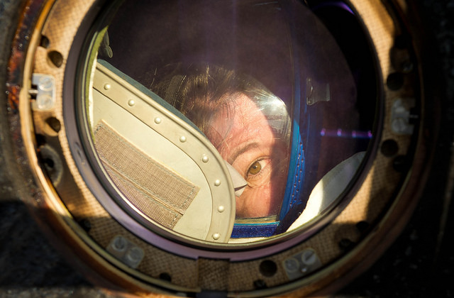 Astronaut Cady Coleman peeks out of a window of the Soyuz TMA-20 spacecraft. Photo by NASA Goddard Space Flight Center